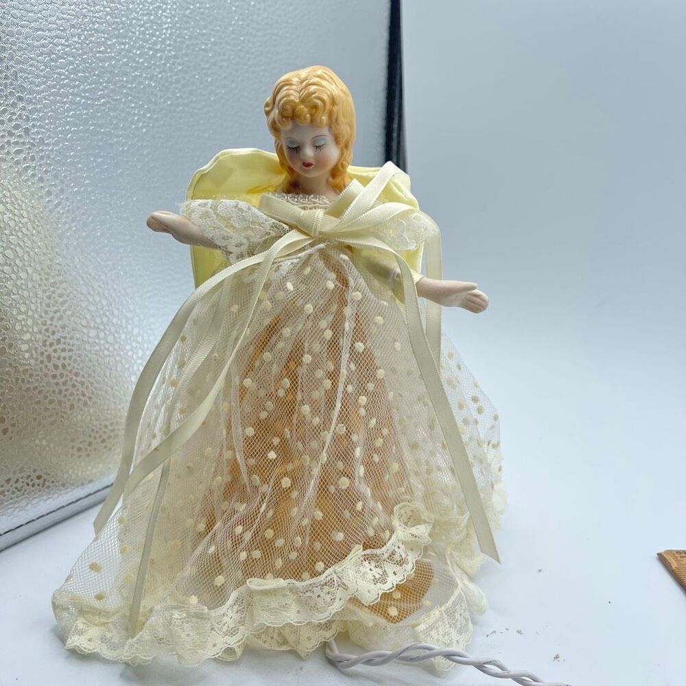Vintage illuminated porcelain-head angel Christmas tree topper.